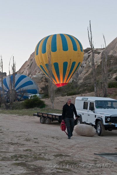 20100405_062836 D300.jpg - Pilot carrying his materials (Note a background balloon being 'fired up')